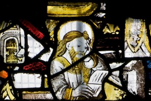 A religious man reading, a detail from a fifteenth century window at the All Saints' Church, Gresford.
